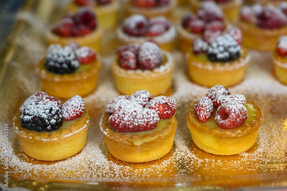 Wild strawberry and raspberry cakes in ancient city of strawberry Nemi, Castelli Romani, Italy Wild strawberry and raspberry cakes in ancient city of strawberry Nemi, Castelli Romani, Italy