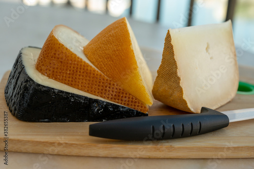 Cheese collection, French fol epi  cheese with many little holes, etorki, tomme noire des pyrenees and ossau iraty cheese photo