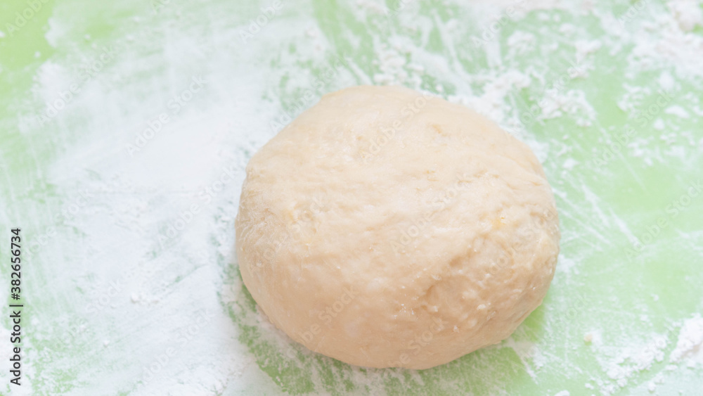 The process of raising the dough on the light green plastic board. Dough made from natural sourdough and organic wheat dough. The successful of ferrmentation stag for bakery.