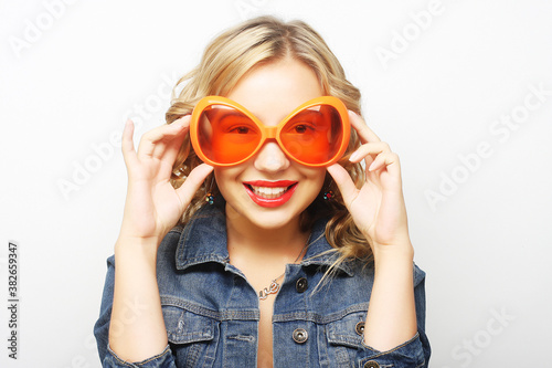 young happy woman with big orange sunglasses