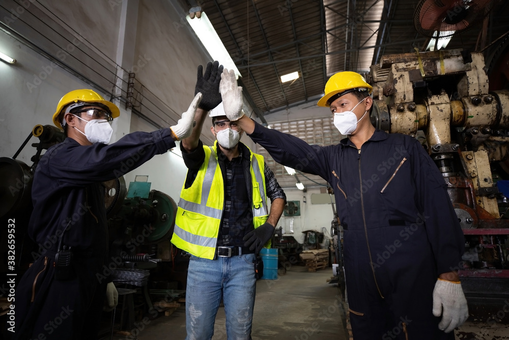 group of industrial technician worker giving high five or raise hands for success the project together in factory, new normal concept group of industrial technician worker giving high five or raise hands for success the project together in factory, new normal concept