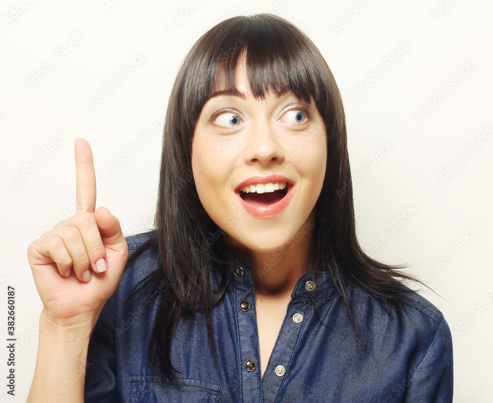 Young woman with her finger up. Good idea! Young woman with her finger up. Good idea!