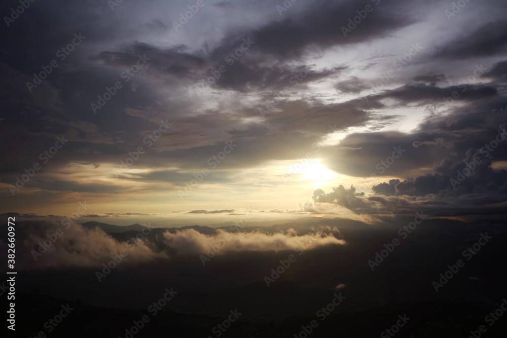 Destination twilight and paradise of golden sunrise and sunset shining to the mist and fog in the jungle on the valley mountain. Aerial view of Rainy season in the tropical rainforest in Thailand. Destination twilight and paradise of golden sunrise and sunset shining to the mist and fog in the jungle on the valley mountain. Aerial view of Rainy season in the tropical rainforest in Thailand.