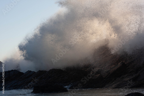 The wave crashing over a cliff