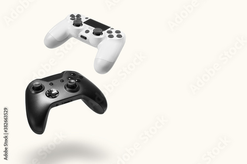 White and black game controllers on white background photo