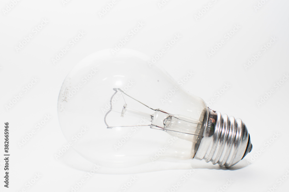 an outdated incandescent lamp with a base lies on a white background. isolate light bulb an outdated incandescent lamp with a base lies on a white background. isolate light bulb