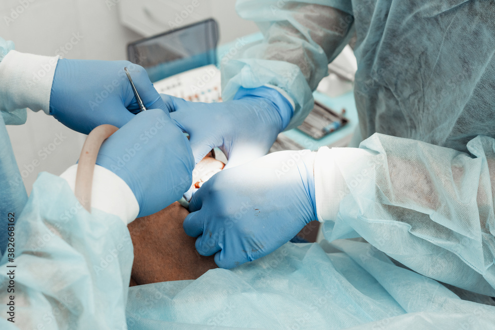 Dentists will perform an operation, implant placement. Real operation. Tooth extraction, implants. Professional uniform and equipment of a dentist. Healthcare Equipping a doctor’s workplace. Dentistry Dentists will perform an operation, implant placement. Real operation. Tooth extraction, implants. Professional uniform and equipment of a dentist. Healthcare Equipping a doctor’s workplace. Dentistry