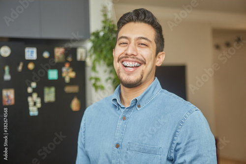 portrait of a hispanic young man with braces