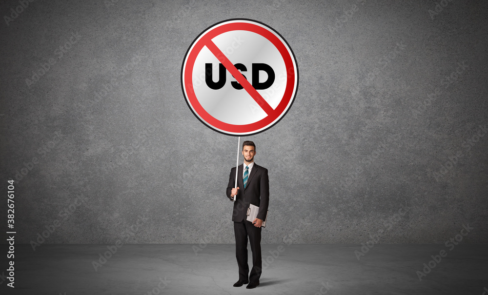 Young business person holdig traffic sign with USD abbreviation, technology solution concept Young business person holdig traffic sign with USD abbreviation, technology solution concept