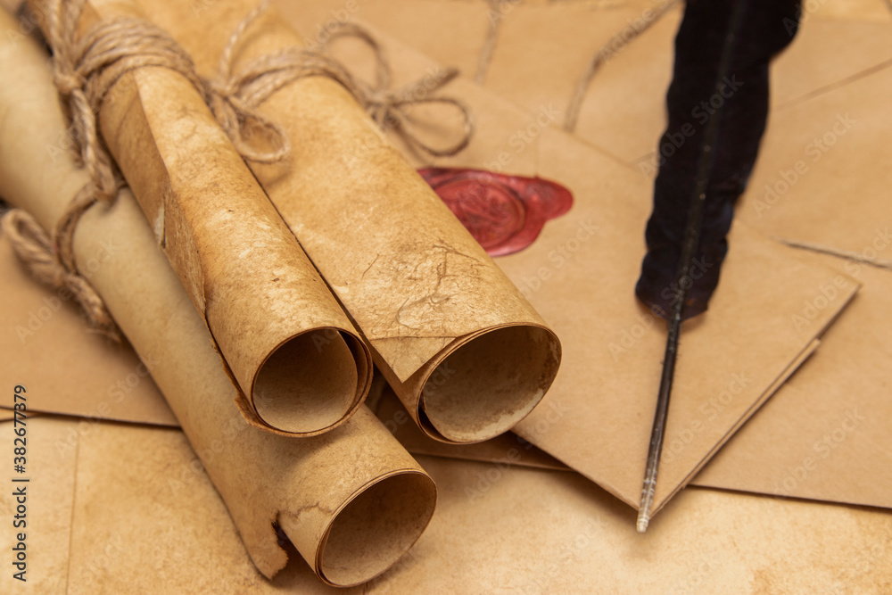 Old paper scrolls, pen for writing. Envelope sealed with a seal and ...
