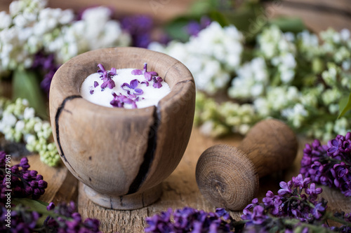 Lilac sugar with a wooden pestle and mortar