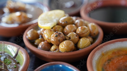 Green olive with lemon plate in breakfast table.Close up shot.