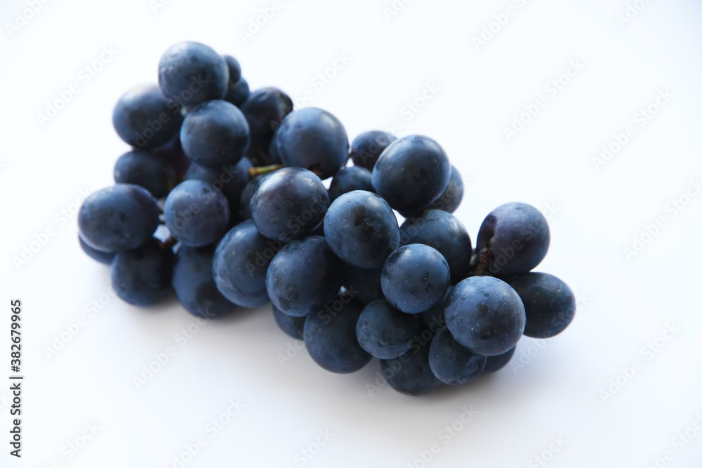 Branch of black grapes on a white background. Branch of black grapes on a white background.