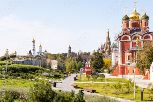 cathedral of Znamensky monastery in the Old Tsar's yard in Zaryadye urban landscape public park on Varvarka street and view of Kremlin on background in Moscow city on sunny September day