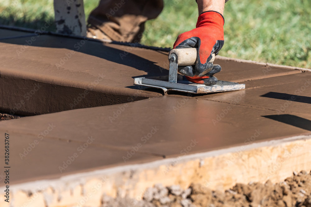 Construction Worker Using Hand Groover On Wet Cement Forming Coping Around New Pool Construction Worker Using Hand Groover On Wet Cement Forming Coping Around New Pool