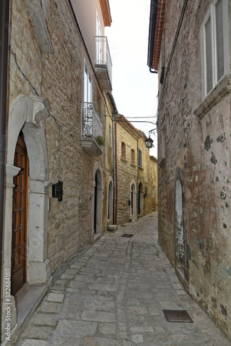Fototapeta Naklejka Na Ścianę i Meble -  A narrow street among the old houses of Ferrazzano, a medieval village in the Molise region.
