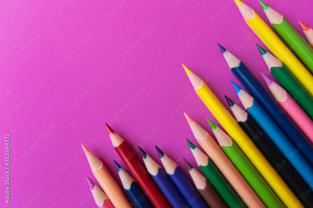 A lot of colour pencils on the pink background. Back to school. A lot of colour pencils on the pink background. Back to school.
