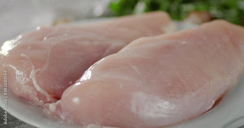 The plate with fresh chicken fillet rotates slowly. The plate with fresh chicken fillet rotates slowly.