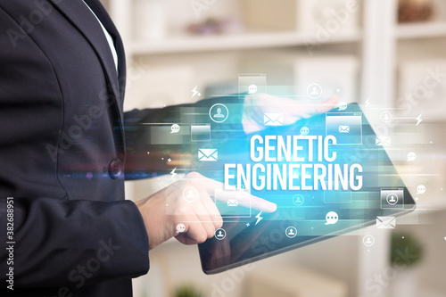 Close-up of a tablet searching GENETIC ENGINEERING inscription, modern technology concept © ra2 studio