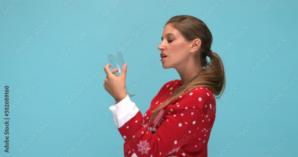 Studio, slow motion, an intense young woman poses with an empty wine glass Studio, slow motion, an intense young woman poses with an empty wine glass
