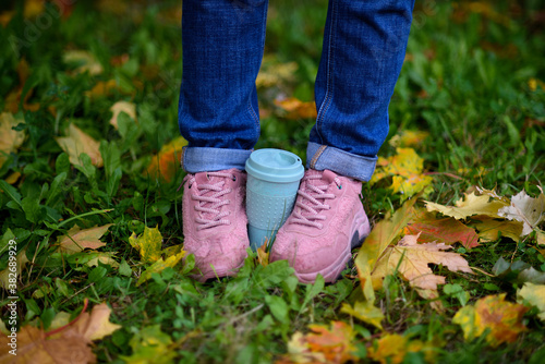 Pink fluffy sneakers and autumn leaves