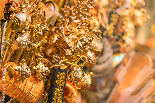 Auspicious rake or kissho kumade ornate of golden mallets of fortune and bales of rice of the God of Wealth Daikoku, of turtles and dragon during Tori-no-Ichi Fair. photo