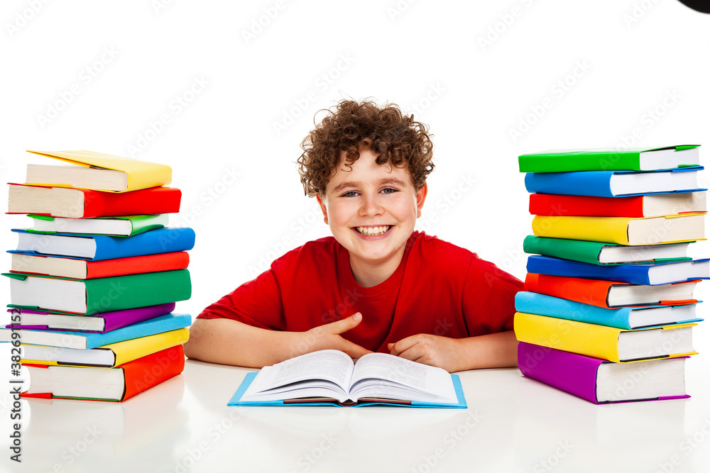 Boy behind pile of books isolated on white background Boy behind pile of books isolated on white background
