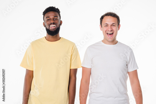 Two handsome men posing together isolated over white background
