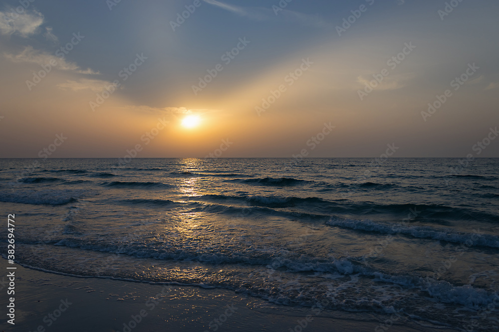 Amazing sunset at the beach. Evening time. Closeup water.