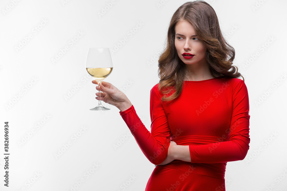 Woman with makeup, hairstyle waering red dress posing with glass of vine over white background, isolate. Woman with makeup, hairstyle waering red dress posing with glass of vine over white background, isolate.