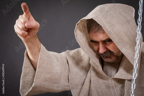 Halloween concept. The judge of the holy inquisition pronounces judgment on the sinner