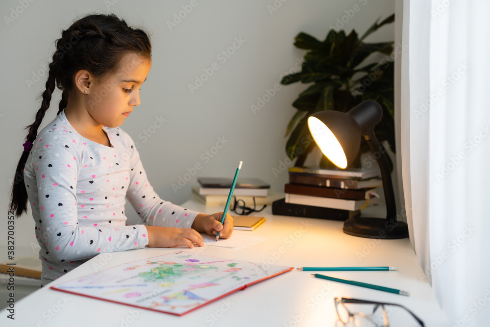 children, education and learning concept - student girl with book writing to notebook at home children, education and learning concept - student girl with book writing to notebook at home