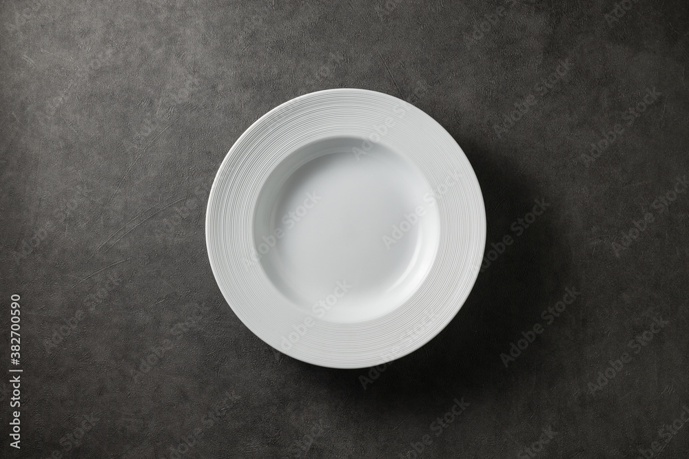 beautiful modern plate on a dark gray concrete background, top view beautiful modern plate on a dark gray concrete background, top view