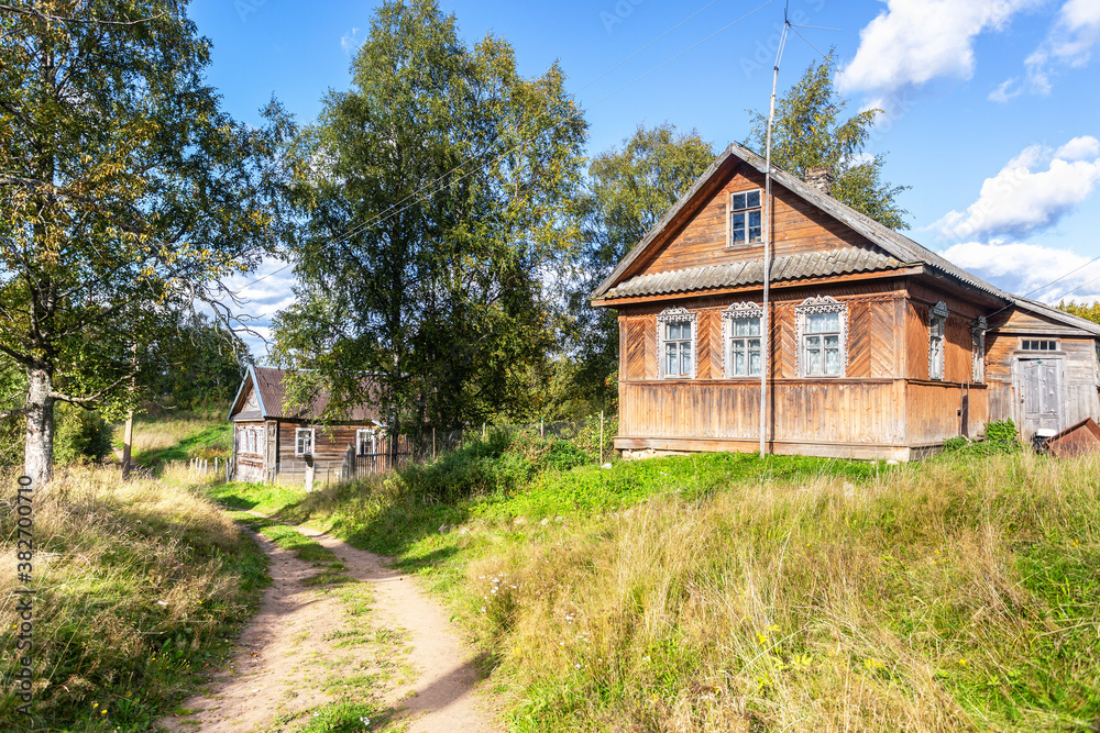 Traditional old rural wooden houses in russian village