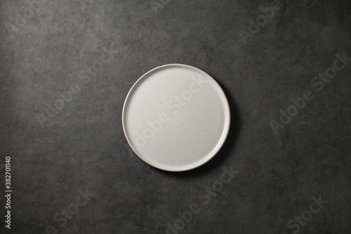 beautiful modern plate on a dark gray concrete background  top view