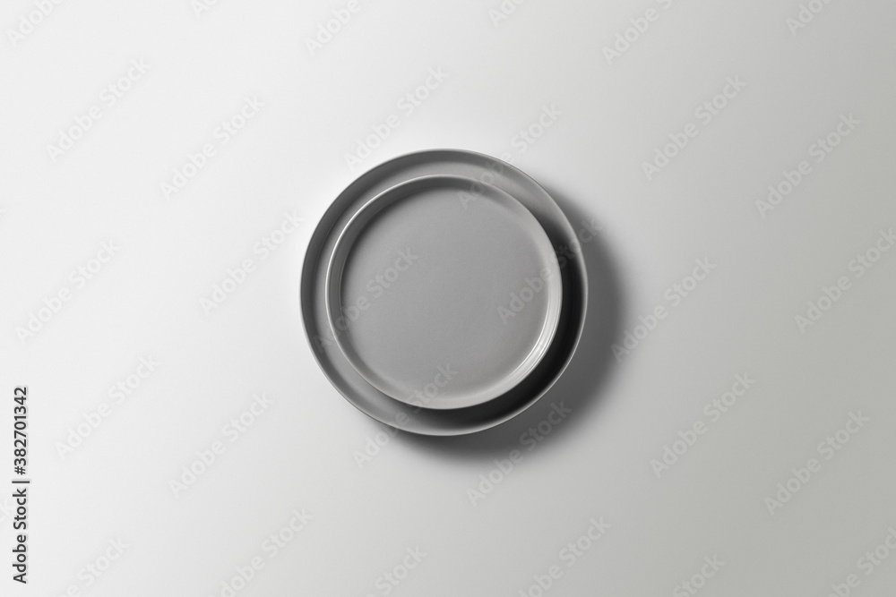 two beautiful gray plates on a white background, top view
two beautiful gray plates on a white background, top view