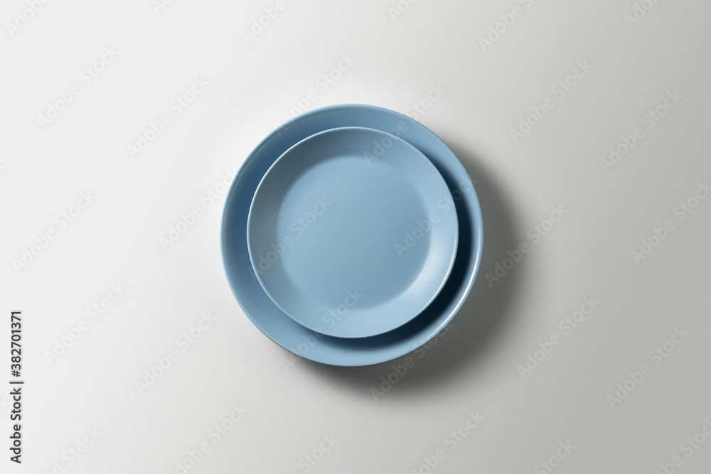 two beautiful blue plates on a white background, top view
two beautiful blue plates on a white background, top view
