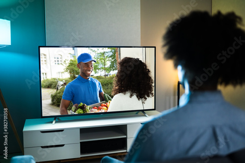 African Man Watching TV Movie photo