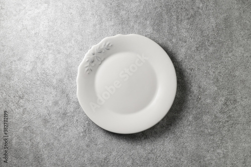 beautiful vintage plate on gray concrete background  top view 