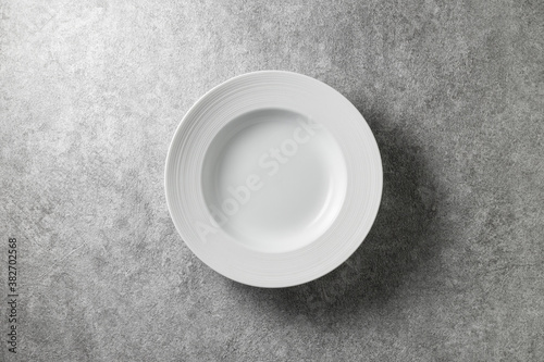 beautiful white plate on gray concrete background  top view