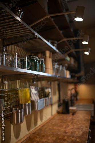 Part of the kitchen interior with wooden shelves and dishes
