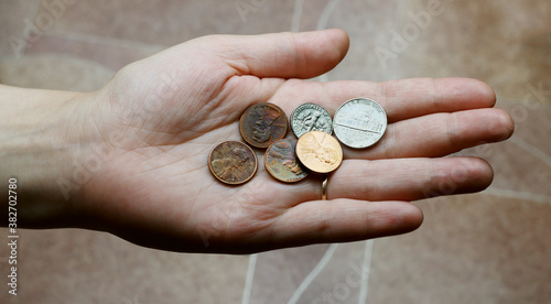 US coins, cents in hand, concept: poverty, success, loan, rich