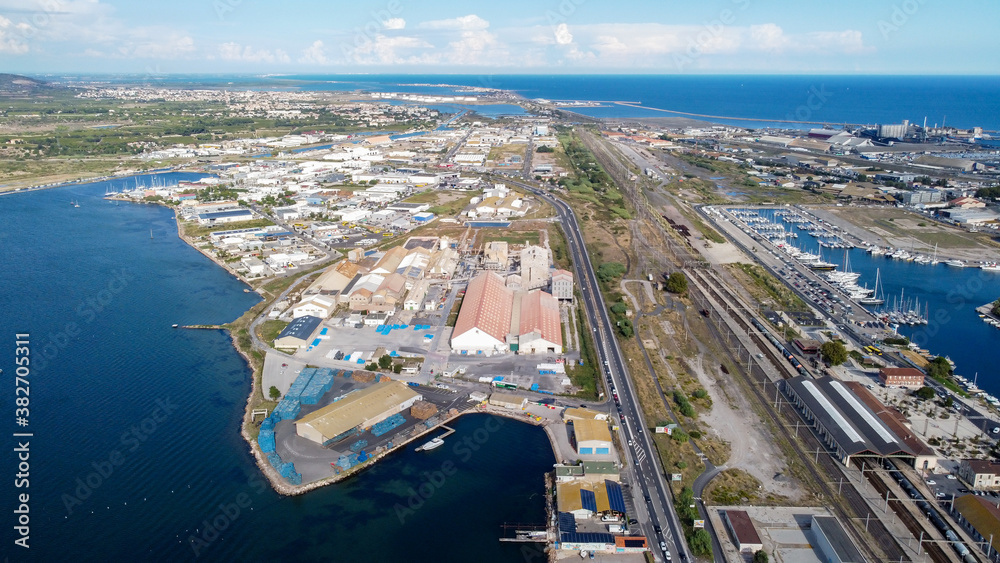 Aerial view of the train station of Sete in the South of France, next to an industrial area - Railway transportation along the Mediterranean Sea