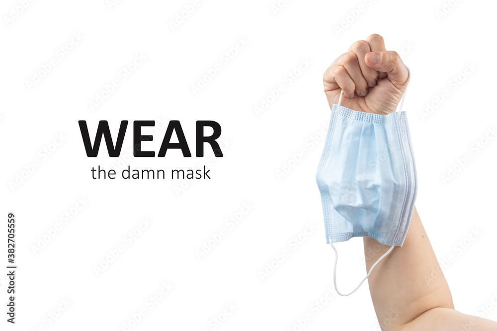 Wear the mask concept. Person hold face mask in a hand due to epidemic. Isolated on white background. Copy space