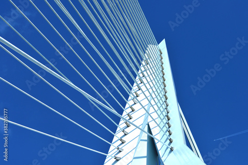 Multiple strings of a bridge abutment against blue sky