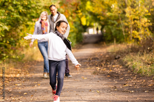happy family Walking through autumn park