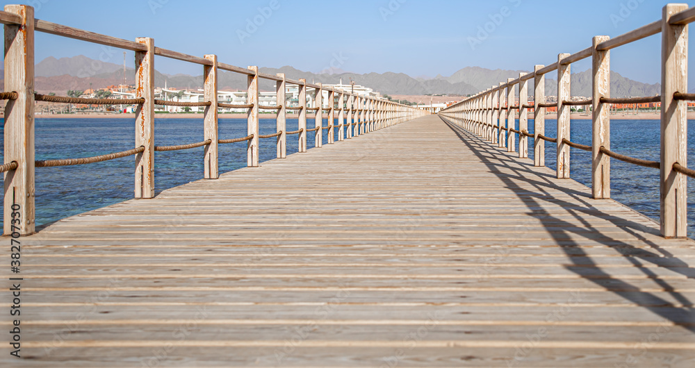 Naklejka premium The background is a beautiful wooden long pier