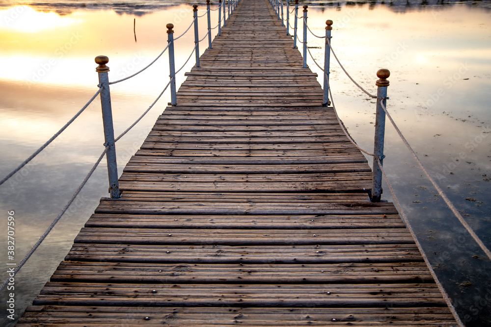 The background is a beautiful wooden long pier