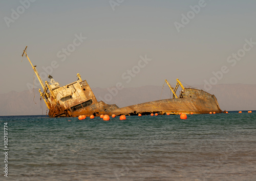 Sunset view of shipwreck in the Gulf of Aqaba off the Saudi Arabian coast, Haql Province photo