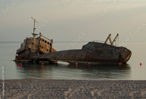 Sunset view of shipwreck in the Gulf of Aqaba off the Saudi Arabian coast, Haql Province photo